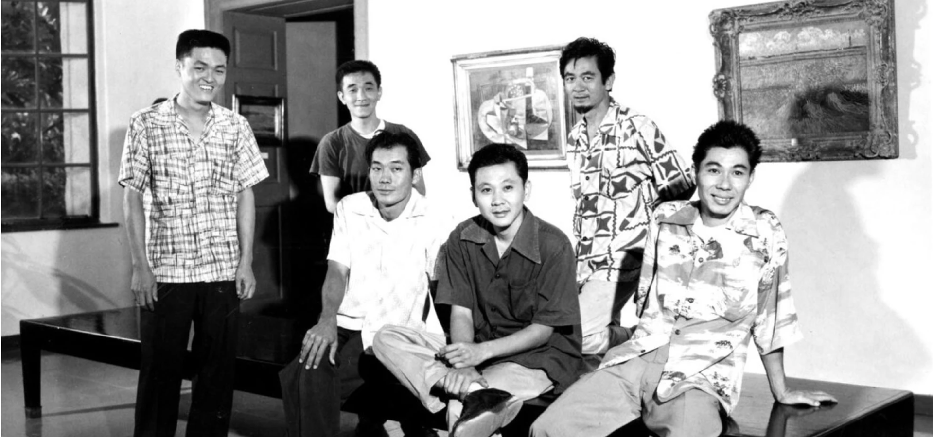 Satoru Abe, third from right, with the Metcalf Chateau group at the Honolulu Museum of Art in 1954. They are in the gallery where their work would soon be featured in a group show. Pictured with Abe are, from left, Edmund Chung (not featured in the exhibition), Tadashi Sato, Jerry Okimoto, Abe, Bumpei Akaji, and Tetsuo “Bob” Ochikubo.  